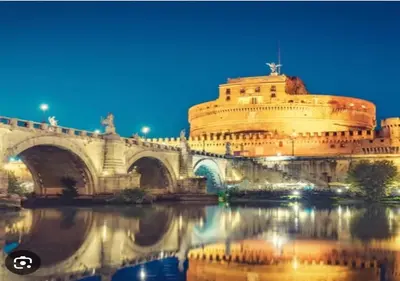 a building next to a bridge and a river at Paradise Vatican Home in Rome