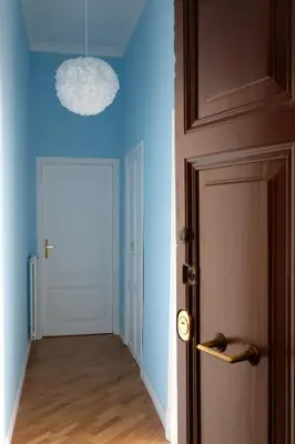 a door with a blue light in a hallway at In the district of Dolce Vita di Fellini in Rome