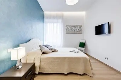 a bedroom with a bed and a tv on a wall at Vatican Brothers in Rome