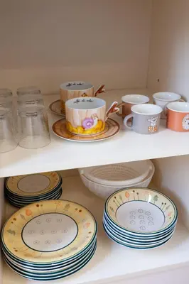 a shelf full of plates and cups and dishes at Studio Piramide in Rome