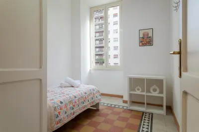 a small bedroom with a bed and a window at Studio Piramide in Rome