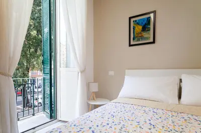a bedroom with a bed and a large window at Studio Piramide in Rome