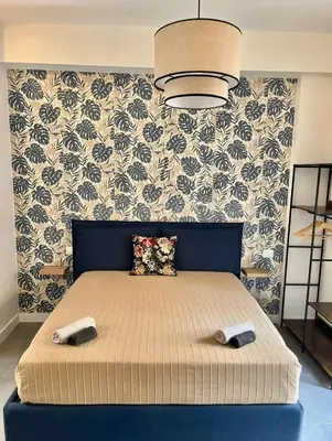 a bedroom with a bed with a blue head board at CASA FRANCISCA - New Boutique Apartment in Rome