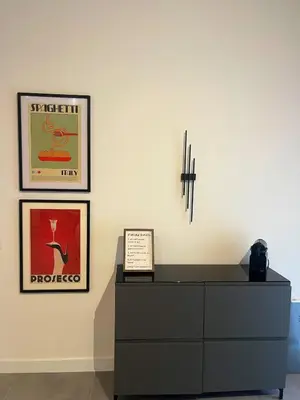a room with a dresser and two pictures on the wall at CASA FRANCISCA - New Boutique Apartment in Rome