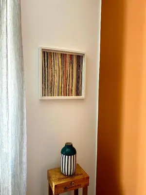 a vase on a table next to a painting on a wall at CASA FRANCISCA - New Boutique Apartment in Rome