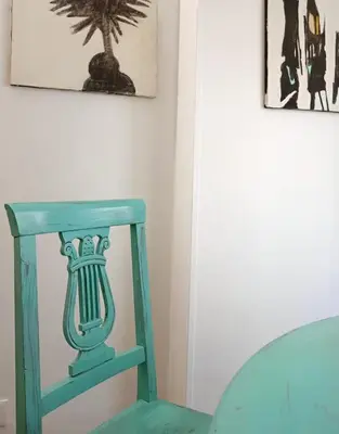 a blue chair in a room with two pictures on the wall at A Casa di Adriana in Rome