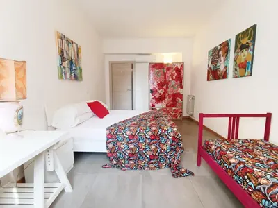 a bedroom with two beds and a desk at A Casa di Adriana in Rome