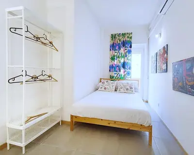 a white bedroom with a bed and a window at A Casa di Adriana in Rome