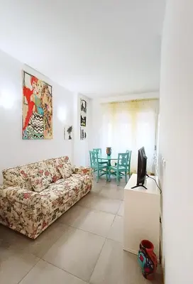 a living room with a couch and a tv at A Casa di Adriana in Rome