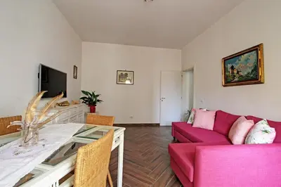 a living room with a red couch and a table at A casa di Chloe - Ponte Milvio in Rome