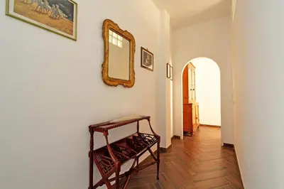 a hallway with a mirror and a wooden floor at A casa di Chloe - Ponte Milvio in Rome