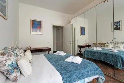 a hotel room with two beds and a mirror at A casa di Chloe - Ponte Milvio in Rome