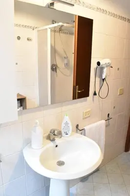 a bathroom with a sink and a mirror at Teresa Amor INN Roma in Rome