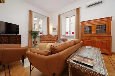 a living room with a couch and a table at TreasureRome Adriana Charme 4BR in Rome