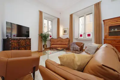 a living room with a couch and a table at TreasureRome Adriana Charme 4BR in Rome