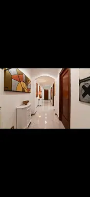 a room with a hallway with a painting on the wall at Mamma ROMA ART in Rome