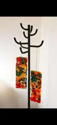 a metal pole with two pieces of art hanging from it at Mamma ROMA ART in Rome