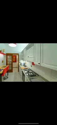 a kitchen with white cabinets and a stove top oven at Mamma ROMA ART in Rome