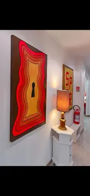 a room with a lamp and a painting on the wall at Mamma ROMA ART in Rome