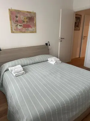 a bedroom with a bed with two towels on it at Charlie Apartment 1C in Rome