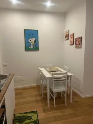 a dining room with a white table and chairs at Charlie Apartment 1C in Rome