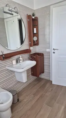 a bathroom with a sink and a mirror and a toilet at Nuovissimo appartamento zona Vaticano Aurelio in Rome