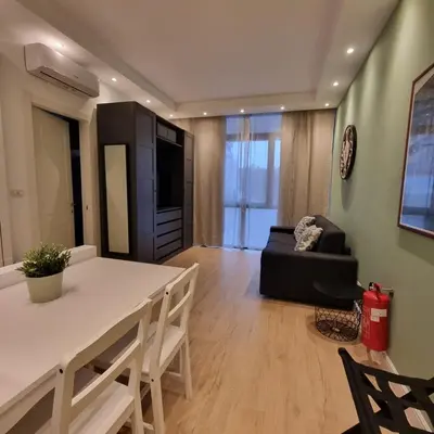 a kitchen and living room with a table and a couch at Vaticano Appartamento Suite Roma Centro Aura D2 in Rome