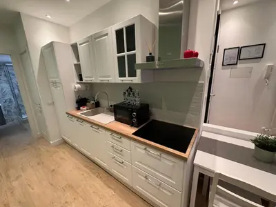 a kitchen with white cabinets and a sink at Vaticano Appartamento Suite Roma Centro Aura D2 in Rome