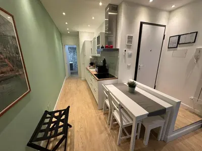 a kitchen with a white table and chairs and a sink at Vaticano Appartamento Suite Roma Centro Aura D2 in Rome