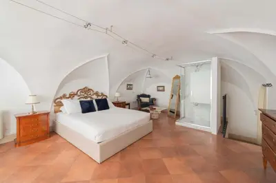 a living room with a staircase and a table and chairs at Beatrix Apartment in Trastevere by Nosdom Properties in Rome