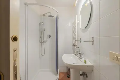 a bedroom with a large bed and a tv at Beatrix Apartment in Trastevere by Nosdom Properties in Rome