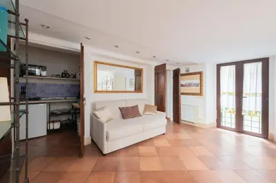a dining room with a table and chairs and stairs at Beatrix Apartment in Trastevere by Nosdom Properties in Rome