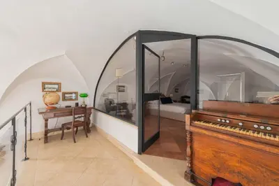a room with a large archway and a mirror at Beatrix Apartment in Trastevere by Nosdom Properties in Rome