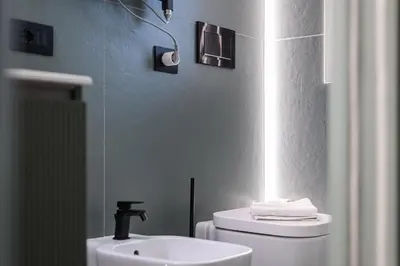 a bathroom with a white toilet and a sink at Casina Doria Pamphili in Rome