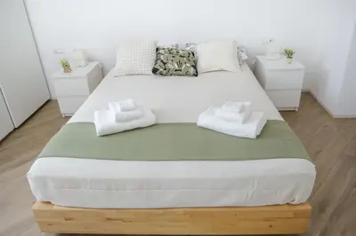 a bedroom with a large bed with towels on it at Rome Urban Retreat - Metro A in Rome