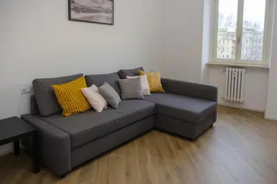 a gray couch with pillows on it in a living room at Rome Urban Retreat - Metro A in Rome