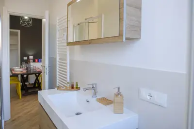 a bathroom with a white sink and a mirror at Rome Urban Retreat - Metro A in Rome
