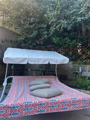 a bed with pillows sitting on top at Happy House with private garden in Rome