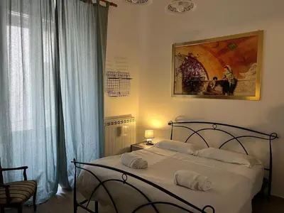 a bedroom with a bed with white towels on it at Saint Peter & Giulio Cesare in Rome