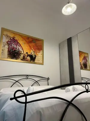 a bedroom with a bed and a painting on the wall at Saint Peter & Giulio Cesare in Rome