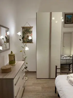 a bedroom with a dresser and a mirror at Saint Peter & Giulio Cesare in Rome