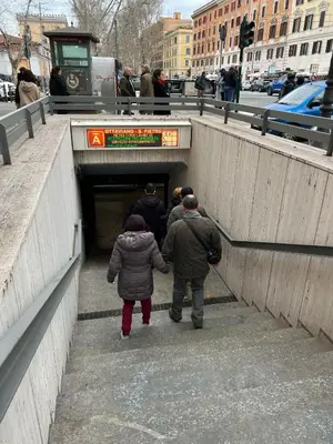 a group of people walking into a subway tunnel at Saint Peter & Giulio Cesare in Rome