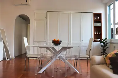 a dining room with a glass table and chairs at Saint Bon Dream in Rome