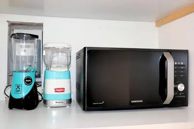 a kitchen counter with a microwave and a blender at Saint Bon Dream in Rome