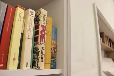 a row of books sitting on a shelf at Saint Bon Dream in Rome