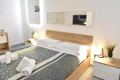 a bedroom with a large bed with a television on the wall at Banksy house in Rome intero appartamento in Rome
