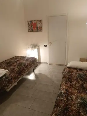 a room with two beds and a door in it at Banksy house in Rome intero appartamento in Rome