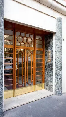 a store front with a glass door with metal bars at Eleganza&Confort in Roma-Liberty- in Rome