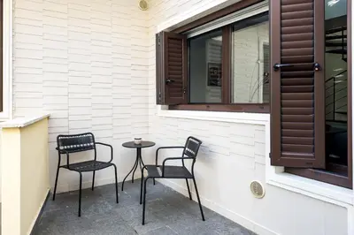 two chairs and a table in front of a window at The Spiral Way - Trastevere apartment with large private terrace in Rome