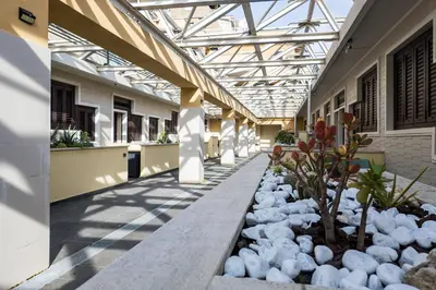 a hallway of a building with a glass ceiling at The Spiral Way - Trastevere apartment with large private terrace in Rome